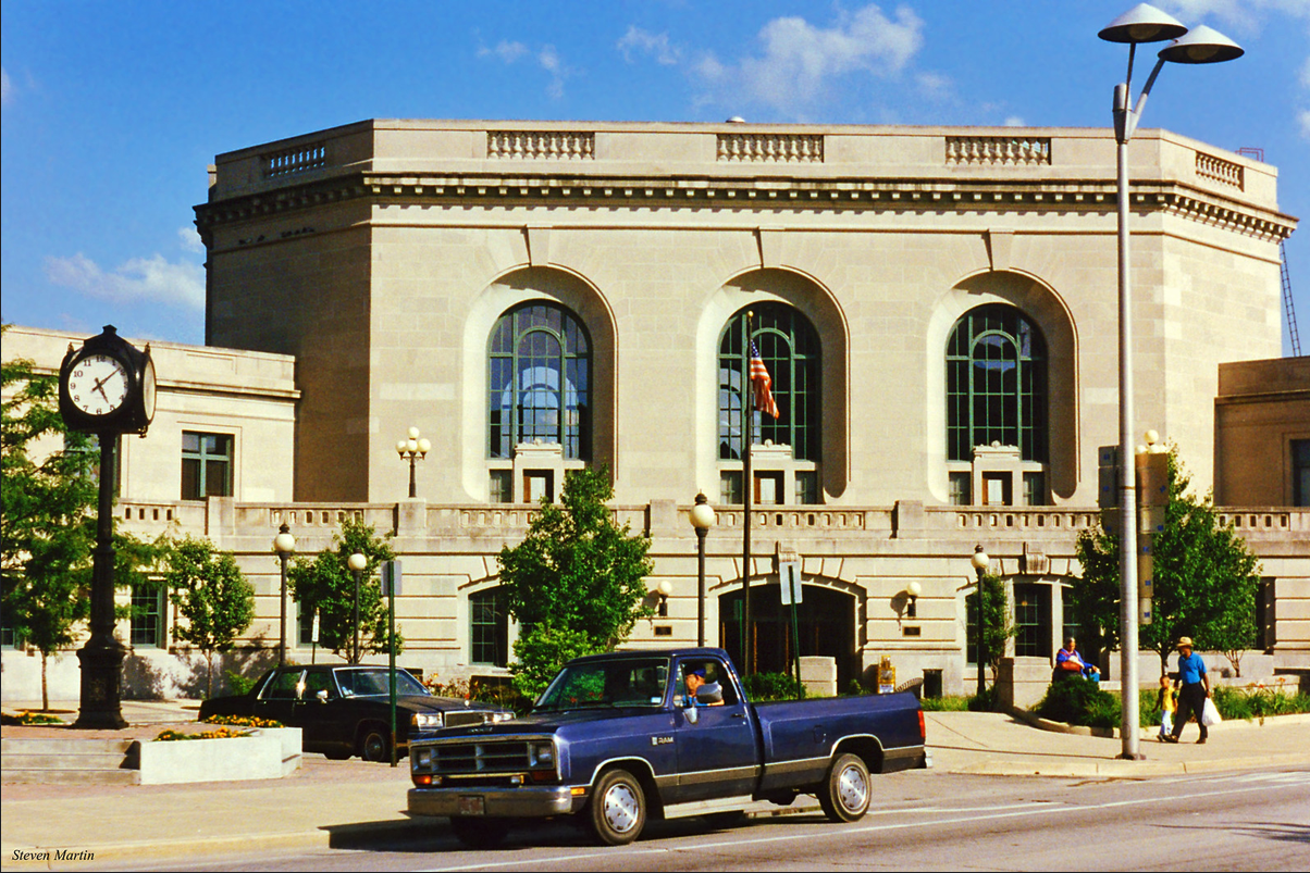 Joliet City Hall on a bright summer day, a stone civic building with tall arched windows